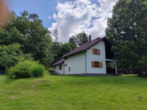 a white house in a field with trees at Country Villa Velebit, Sveti Rok, Lika in Sveti Rok