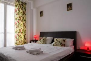 a bedroom with a bed with two towels on it at OPIA Apartments - Old Town in Bucharest