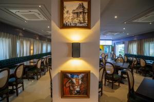 a restaurant with a picture of a horse on the wall at Tiger's Trail Hotel & Food Court in Kumbhalgarh