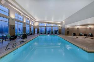 a large swimming pool with blue water in a building at Residence Inn by Marriott Pullman in Pullman