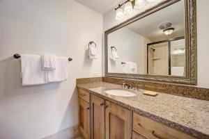 a bathroom with a sink and a mirror at Resort Plaza 5012 by AvantStay Located in Park City Mountain Resort w Mountain Views in Park City