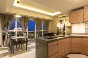 a kitchen and dining room with a view of the city at Luxury Condo at Venice Mall near Airport, BGC & Makati in Manila