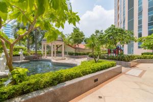 a swimming pool in a park with trees and buildings at Luxury Condo at Venice Mall near Airport, BGC & Makati in Manila