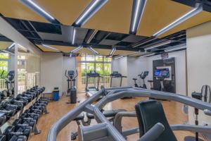 a gym with rows of treadmills and machines at Luxury Condo at Venice Mall near Airport, BGC & Makati in Manila