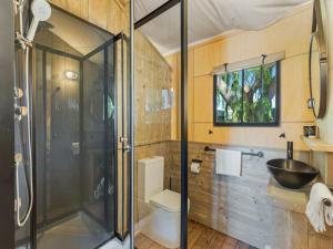 a bathroom with a shower and a toilet and a sink at BIG4 Bendigo Marong Holiday Park in Marong