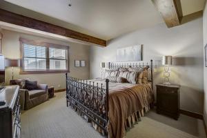 a bedroom with a bed and a chair and a window at Mont Cervin 24 by AvantStay Luxury Ski in Ski out home in Park City in Park City