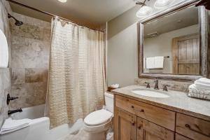 a bathroom with a toilet and a sink and a mirror at Mont Cervin 24 by AvantStay Luxury Ski in Ski out home in Park City in Park City