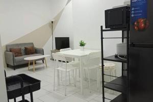 a living room with a white table and a couch at 3 Bedrooms -Astetica-The Mines in Seri Kembangan