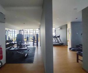 a gym with treadmills and chairs in a room at 3 Bedrooms -Astetica-The Mines in Seri Kembangan