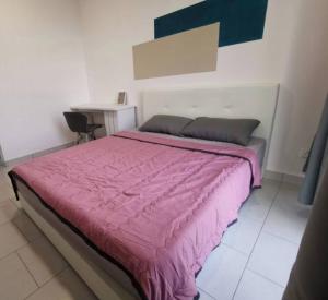 a bedroom with a large bed with a pink blanket at 3 Bedrooms -Astetica-The Mines in Seri Kembangan