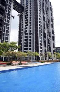 a large building with a large blue swimming pool at 3 Bedrooms -Astetica-The Mines in Seri Kembangan