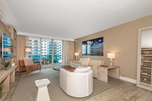 a living room with a white couch and a table at 1 Hotel Modern King Suite 1BR 1 5BA w Ocean View in Miami Beach