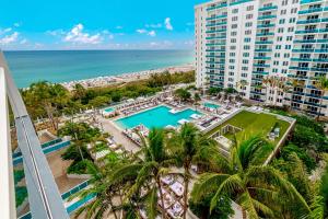 an aerial view of a resort with a pool and the ocean at 1 Hotel Modern King Suite 1BR 1 5BA w Ocean View in Miami Beach