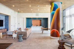 a living room with a couch and a colorful column at Carousel by AvantStay Brand New Condo in Austin w Amazing Amenities in Austin