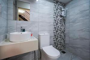 a bathroom with a toilet and a sink and a mirror at Arte Cheras by Just Stay in Kuala Lumpur