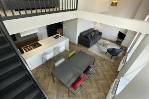 an overhead view of a living room with a table and a couch at Stayci Serviced Apartments Westeinde in The Hague
