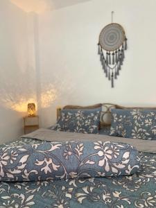 a bedroom with a bed with a blue and white blanket at Studio at the Beach in Ban Ao Makham