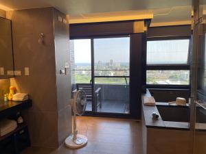 a bathroom with a shower with a view of the city at Spring溫泉 in Toucheng