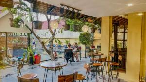 a restaurant with tables and chairs and a pool at Villa Indochine d'Angkor in Siem Reap