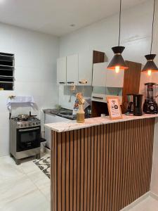 a kitchen with a wooden counter in a kitchen at New House Temporada in João Pessoa