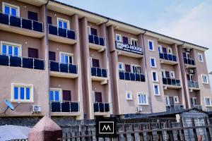 a large building with blue balconies on it at Mohouse Hotels and Apartments Mabushi in Abuja