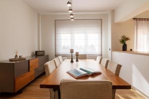 a dining room with a wooden table and chairs at Central Marousi 3BR Gem in Athens