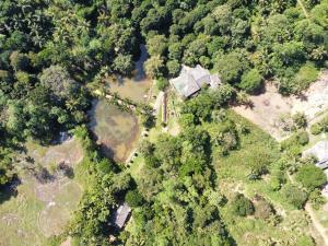 an aerial view of a house with a pond and trees at Madikale Resort in Mirigama