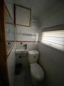 a small bathroom with a toilet and a sink at UCM Adventure Park in San Mateo