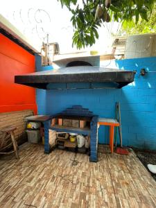an outdoor oven with a table and a bench at Rancho de monica in El Majahual