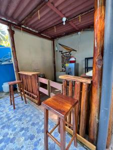 a room with wooden tables and chairs in it at Rancho de monica in El Majahual