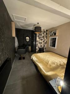 a bedroom with a bed and a chair in it at 13 Nuances De Grey jacuzzi in Marseille
