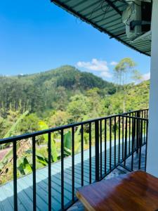 a balcony with a table and a view of a mountain at Ella Silloam in Ella
