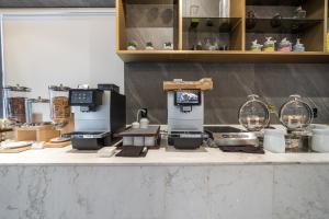 a kitchen counter with many different items on it at Layers Hotel Busan Hadan in Busan