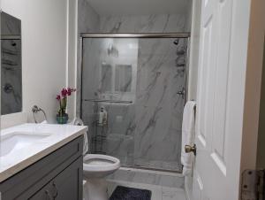 a bathroom with a shower with a toilet and a sink at 2Bedroom with Den and 2BA 4 Blocks to Santa Monica Beach in Los Angeles