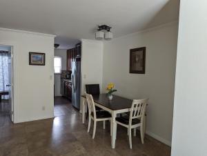 a kitchen and dining room with a table and chairs at 2Bedroom with Den and 2BA 4 Blocks to Santa Monica Beach in Los Angeles