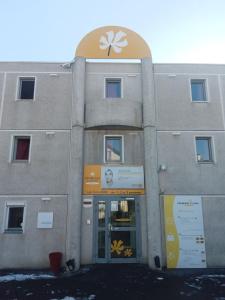 a building with a sign on the front of it at Premiere Classe Saint Brice Sous Foret in Saint-Brice-sous-Forêt