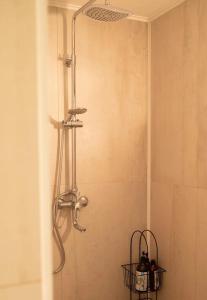 a shower in a bathroom with two baskets at Country House in Almaty