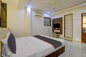 A bed or beds in a room at Hotel Krishna Inn