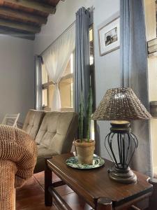 a living room with a couch and a table with a lamp at Sabie Stay in Sabie