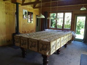 a bedroom with a large bed in a room at Woodland eco retreat in Parapara 