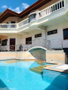 uma casa com uma piscina em frente em Scan House Apartment em Praia de Karon