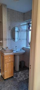 a bathroom with a sink and a mirror at Bearstone House in Loughrea