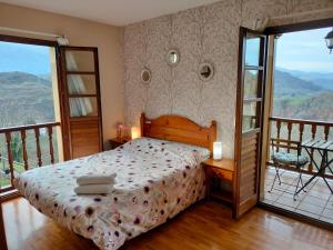 a bedroom with a bed and a balcony at Valle la Fuente in El Escobal