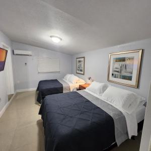 a hotel room with two beds in a room at Cozy Place in Old Seminole Heights + 2 Queen + 1Sofa Bed in Tampa