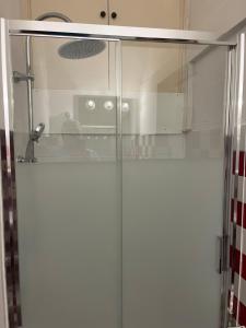 a glass shower door in a bathroom with a sink at Da Mario in Florence Guesthouse in Florence
