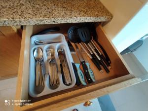 a drawer with silver utensils in a kitchen at Room II MCR Barreiro - Lisboa in Lavradio