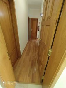 a hallway with two doors and a wooden floor at Room II MCR Barreiro - Lisboa in Lavradio