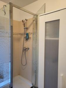 a bathroom with a shower with a glass door at Appartement vue Seine - Duplex 3 terrasses - 3 Chambres in Saint-Ouen