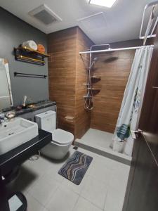 a bathroom with a toilet and a sink and a shower at Radiance Manila bay near CCP, PICC Pasay in Manila