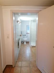 an empty bathroom with a toilet and a sink at Ferienwohnungen Dornröschen in Weißensberg